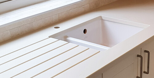Ceramic sink used as  undermount ( drainer grooves and 30mm cutout ) Bone